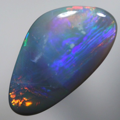 SOLID SEMI BLACK OPAL Large rolling flashes of reds, oranges over blue, purple